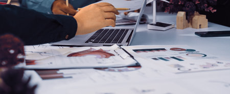 Team members engage in collaborative discussion, analyzing charts and graphs related to...