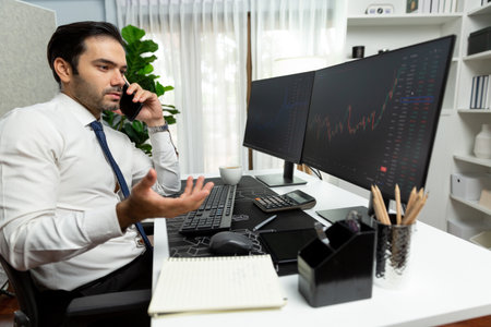 Trader businessman calling to consultant or partner with two stock exchange investment, compare data analysis to invest high profit value dynamic financial technology stock market at office. Surmise.の写真素材