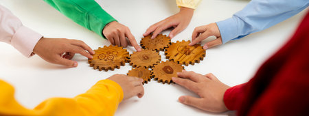 Collaboration and Communication in Teamwork with Diverse Hands Working Together on Wooden Gears Representing Problem Solving and Strategy Development.の写真素材