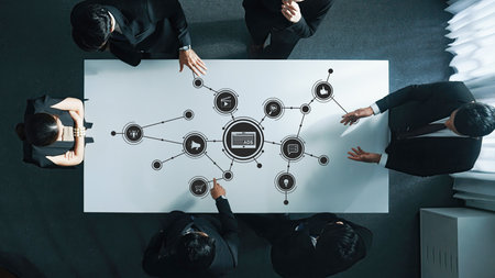 A professional business meeting taking place with a focus on digital marketing concepts. Team...
