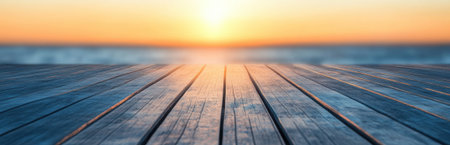 A stunning sunset casts a warm glow over calm waters, viewed from a wooden deck. This tranquil scene captures the beauty of nature, perfect for relaxation.の素材