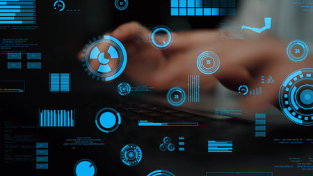 A modern workspace featuring hands typing on a keyboard, surrounded by various digital graphs and metrics in soft blue tones, showcasing advanced data visualization technology.の写真素材