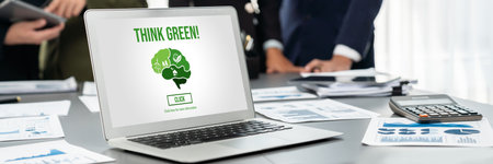 Panorama shot analyst team utilizing BI to analyze financial report with laptop. Businesspeople analyzing BI data dashboard displayed on laptop screen for business insight.の写真素材