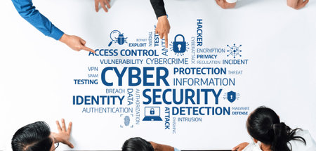 A diverse team collaborates around a table covered with keywords related to cyber security. The...