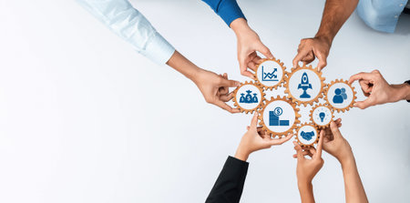 A diverse group of hands working collaboratively with gears and icons, symbolizing business...