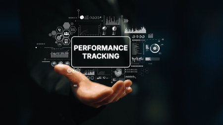 Hand Displaying Digital Performance Tracking Concept with Data Visualization Elements and Graphs on...
