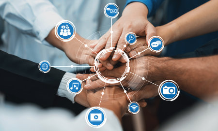A close-up of diverse hands united in collaboration, surrounded by digital media icons that symbolize communication and connectivity in today interactive world. Amityの写真素材
