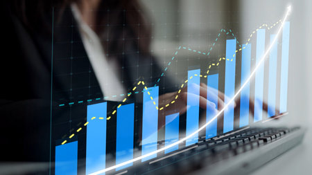 A close-up view of a business professional engaging with a keyboard while analyzing digital growth...