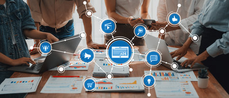 Collaborative Team Meeting with Laptops and Data Visualization Charts in a Modern Office Setting Focused on Digital Marketing Strategies and Analytics.の写真素材