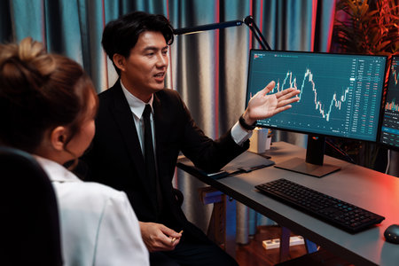 Asian businessman showing dynamic stock exchange currency rate statistic online to share with...