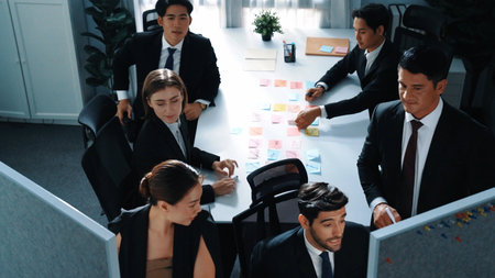 Top view of marketing team brainstorm idea while executive manager write whiteboard and plan financial strategy at meeting room. Group of diverse people working together to solve problem. Directorate.の写真素材