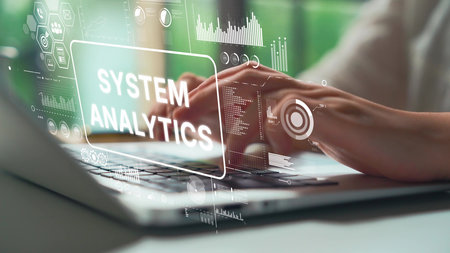 Hands Typing on Laptop with System Analytics Graphic Overlay and Data Visualization Elements in...