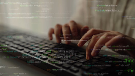 A focused image capturing hands on a keyboard, surrounded by glowing lines of code. This visual represents the world of programming, technology, and software development in a modern workspace.の写真素材