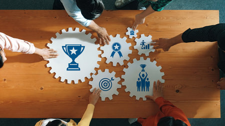 Diverse individuals engage in teamwork, placing illustrated gears and award icons to visualize...