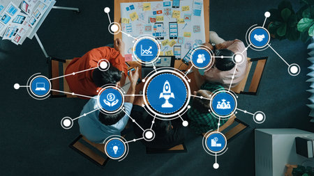 A dynamic overhead view of a collaborative brainstorming session in a modern office, showcasing teamwork and innovative concept development through visual data analysis.の写真素材