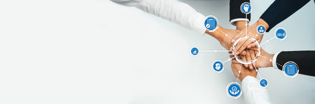 This image depicts a powerful moment of collaboration, featuring hands from diverse professionals...