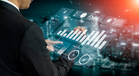 A business professional interacts with a digital analytics display, showcasing data insights and...