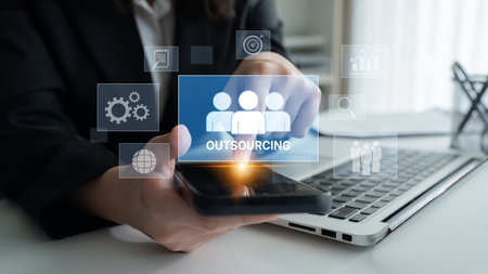 Outsourcing concept showing collaboration, delegation, global workforce, productivity, and task management through remote teams and external service providersの写真素材