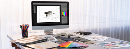Interior designer workspace table and architecture software on laptop screen with mood board...
