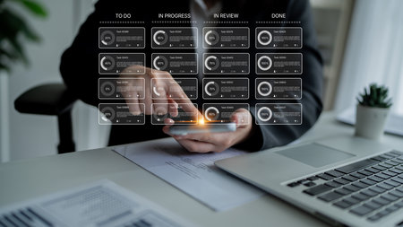 Task management tool dashboard showing kanban-style workflow with columns for to do, in progress, in review, and done, including task cards, progress, and team iconsの写真素材