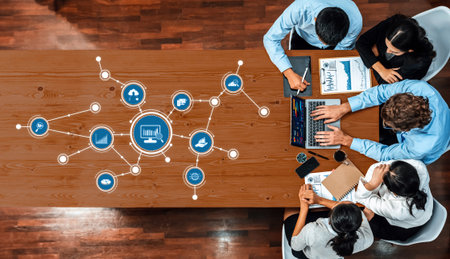 Professionals collaborate in a modern office setting, analyzing data and visualizing insights using digital tools, laptops, and presentations to drive informed decision-making.の写真素材