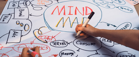 A vibrant mind map created by a group of individuals engaged in brainstorming and planning. The colorful drawings encapsulate thoughts and strategies for projects.の写真素材