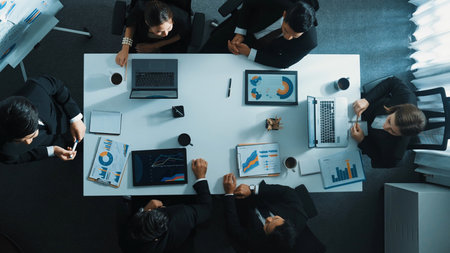 Time lapse of businessman standing at blackboard while holding financial chart and presenting marketing strategy to diverse investor group. Top down view of manager analyzing stock market graph.の写真素材