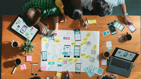 Professional developer team sharing idea of Ux Ui design by using mind map. Top down view of group...