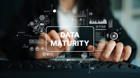 Business Professional Working on Keyboard with Data Maturity Concept Overlaid in Modern Office Setting. Asymptotic smart data analytic.の写真素材
