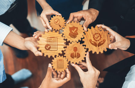 Collaborative Teamwork with Engaged Hands on Wooden Gears Symbolizing Mutual Support, Professional Relationships, and Effective Communication in Business Settings.の写真素材