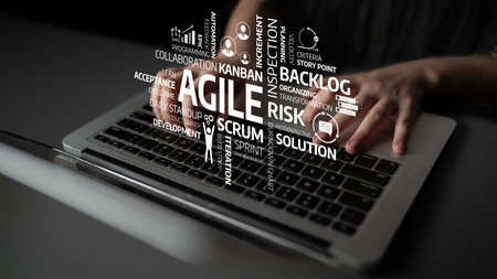 This image features a laptop with hands typing and various agile project management terms floating...