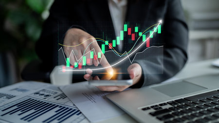 A business professional engages with stock market data on a smartphone, displaying colorful graphs and charts, highlighting modern finance analysis in a stylish office. Imputeの写真素材