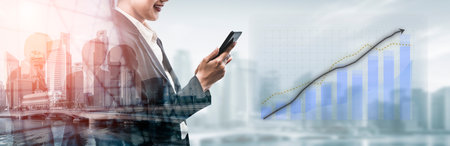 A business professional engages in data analysis with a smartphone, amidst a vibrant urban background, representing financial growth and modern technology. Imputeの写真素材