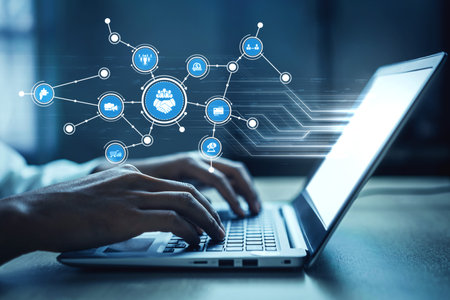 A close-up view of hands typing on a laptop, surrounded by digital icons representing innovation and technology concepts in a contemporary workspace setting. Tesselの写真素材