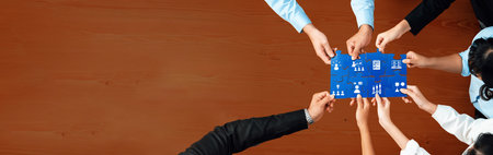 An engaging collaboration scene featuring diverse hands working together on a blue paper layout. The image captures teamwork, strategic planning, and creativity in action.の写真素材