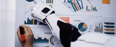 A robotic arm interacts with vibrant business charts, showcasing analysis techniques in an innovative workspace. Ideal for technology-themed presentations and reports.の写真素材