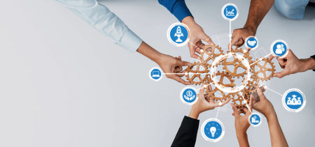 Dynamic teamwork scene with diverse hands engaged in a collaborative effort, symbolizing innovation and growth through interconnected gears and meaningful icons. Amityの写真素材