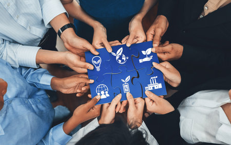 Diverse corporate officer workers collaborate in office, connecting puzzle pieces to represent partnership and teamwork. Unity and synergy in business concept by merging jigsaw puzzle. Concord Amityの写真素材