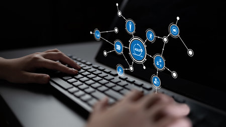 A close-up view of hands typing on a keyboard with a background of digital connections and icons, showcasing the integration of technology and communication in modern workspaces. Tesselの写真素材