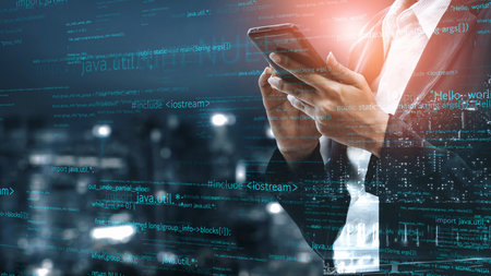 A business professional stands in a modern cityscape at night, using a smartphone surrounded by...
