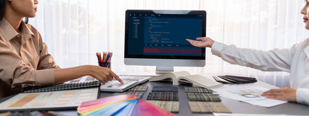 Group of interior architect designer team at table choosing various mood board samples with architecture software on laptop screen. Modern renovation and interior material selection concept. Insightの写真素材