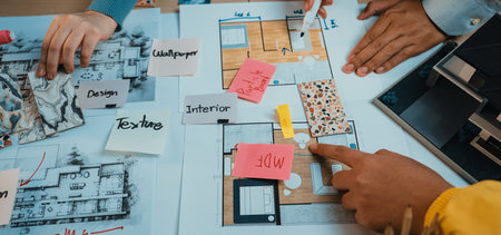 Team members engage in an interactive design process, analyzing colorful mood boards and detailed...