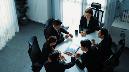 Top view of diverse business team discuss about marketing idea while businessman analyze financial graph from tablet at meeting room. Group of smart team brainstorm idea at conference. Directorate.の写真素材