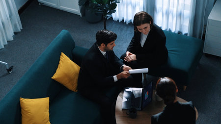 Top view of professional business people analyze stock market investment data by using laptop and financial graph while smart businessman walk out of the meeting room. Creative business. Directorate.の写真素材