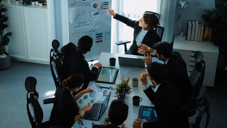 Top view of smart manager project pointing at whiteboard with mind map and financial graph and explain marketing idea while diverse investors listening and analyze stock investment chart. Directorate.の写真素材