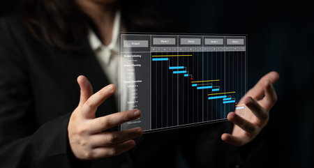 A business professional demonstrates a transparent Gantt chart, emphasizing project management and planning. The modern office backdrop enhances the visual impact. Tesselの写真素材