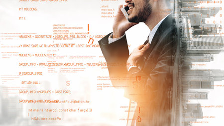 A confident businessman in a suit engages in a phone conversation against an abstract data backdrop,...