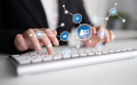 Hands on a keyboard illustrate technology and communication concepts, featuring digital icons that...
