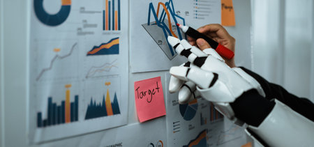 A robotic hand examines various graphs and charts affixed to a wall, showcasing data trends and...
