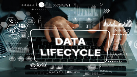 Concept of Data Lifecycle Management with Hands Typing on Laptop Surrounded by Digital Graphics and...